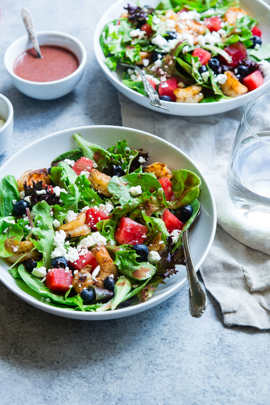Fresh mixed greens in a white bowl